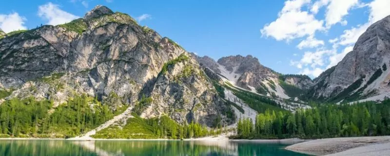 Lake in Dolomites mountains with clouds reflected in the water