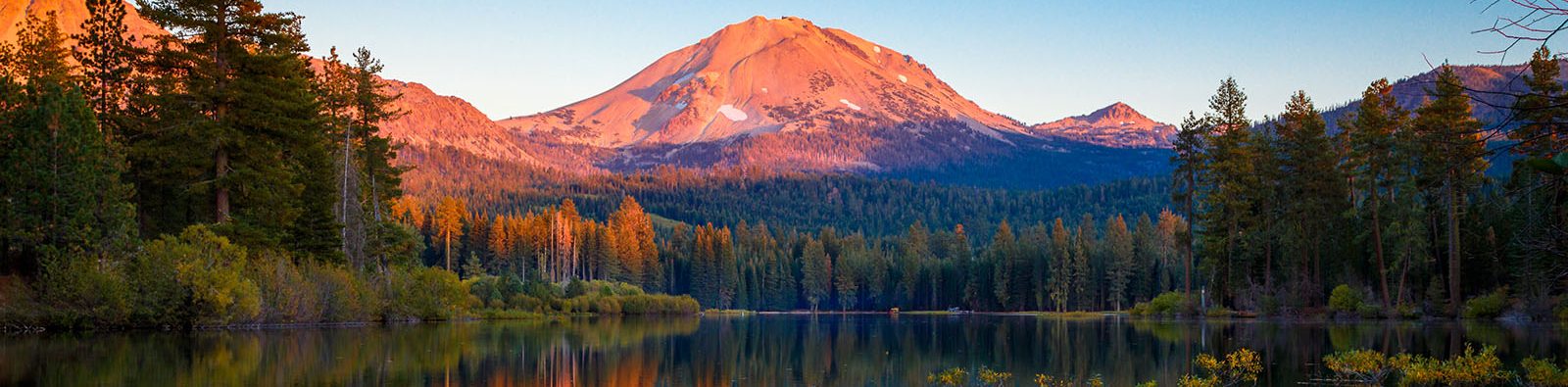 Sunset at Lassen Peak with reflection on Manzanita Lake - wide image