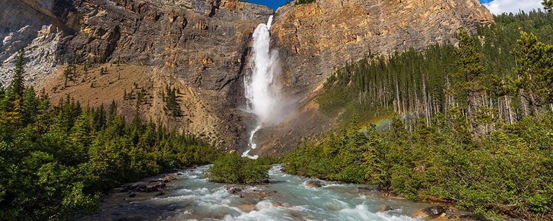 Raging waterfall on rocky cliffs