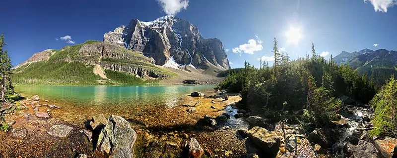 Shallow pool with deeper water and mountains in distance