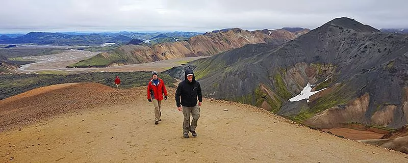 Two hikers on dirt trail