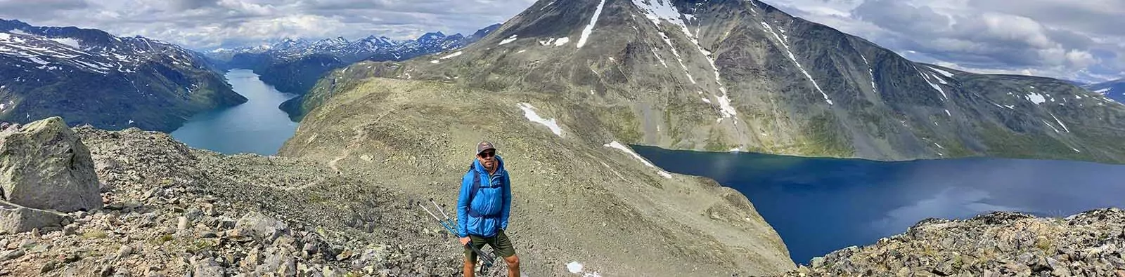 Wildland Trekking guide in front of amazing view of mountains and fjords, Jotunheimen National Park, Norway