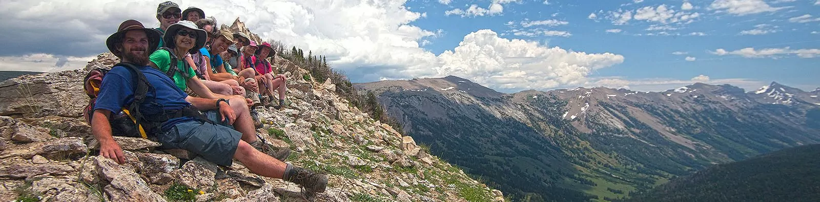 Hikers sitting on a high ridge in the mountains around Jackson Hole