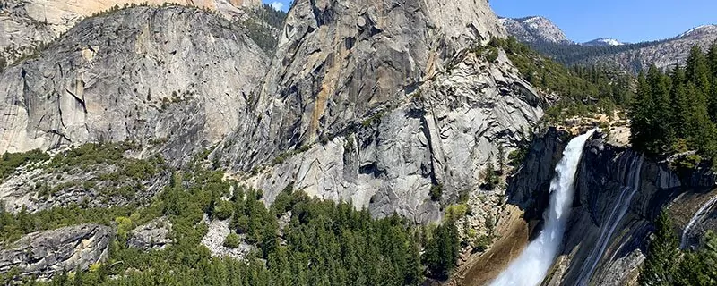 stony mountains with waterfall and shrubs